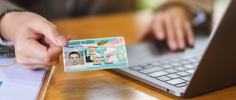 Image of Green Card in a person's hand.